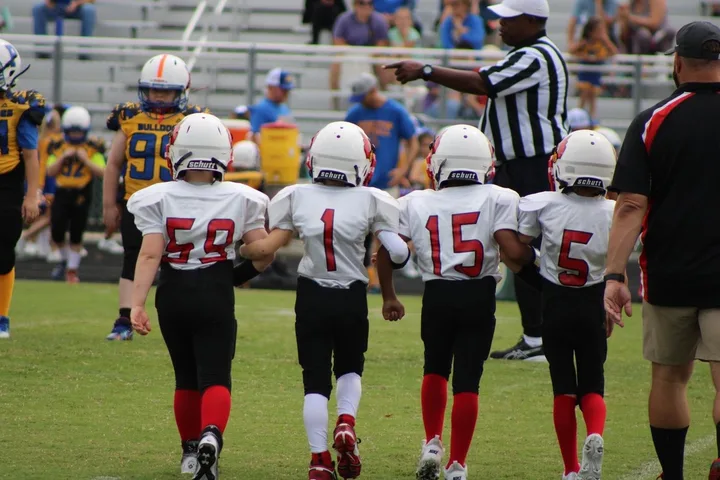 Four Oaks coaches and players on the sideline