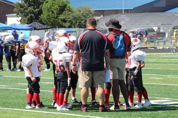 Four Oaks coaches and players on the sideline
