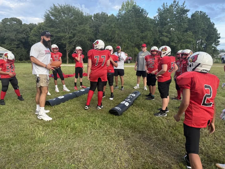 Four Oaks coaches and players on the sideline