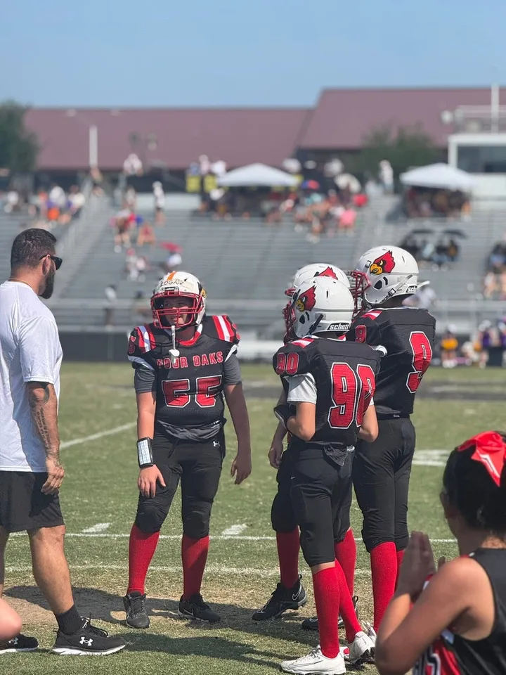 A Four Oaks coach with Four Oaks players on game day