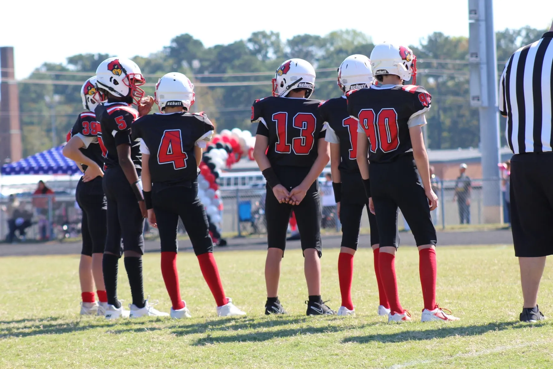 Four Oaks players huddled up between plays on game day
