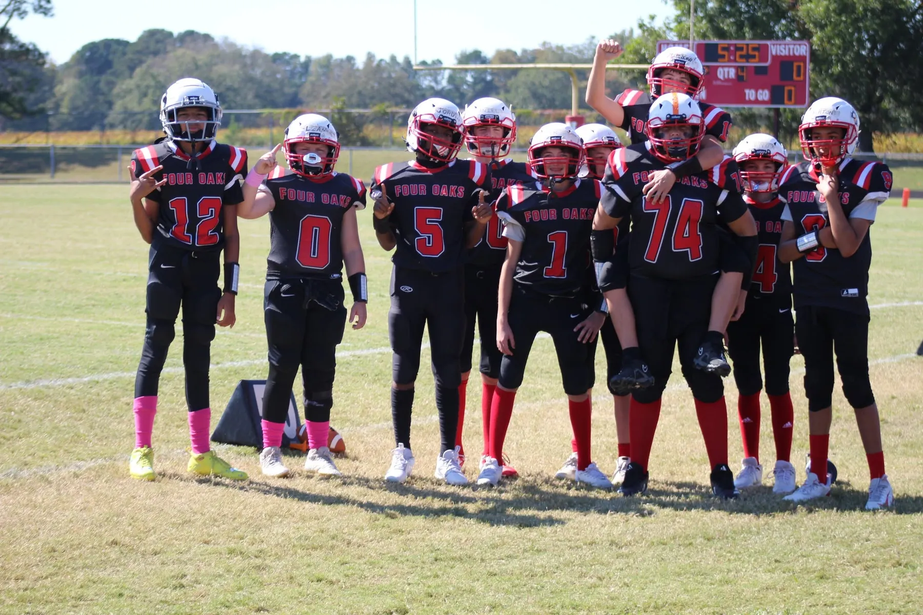 Four Oaks players gathered together on the field