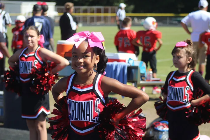 Four Oaks Cardinals cheerleaders on the sideline