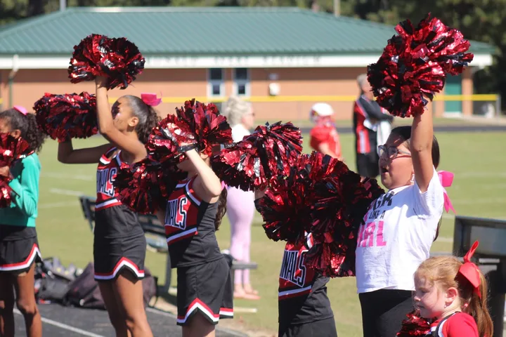 Four Oaks Cardinals cheerleaders on the sideline