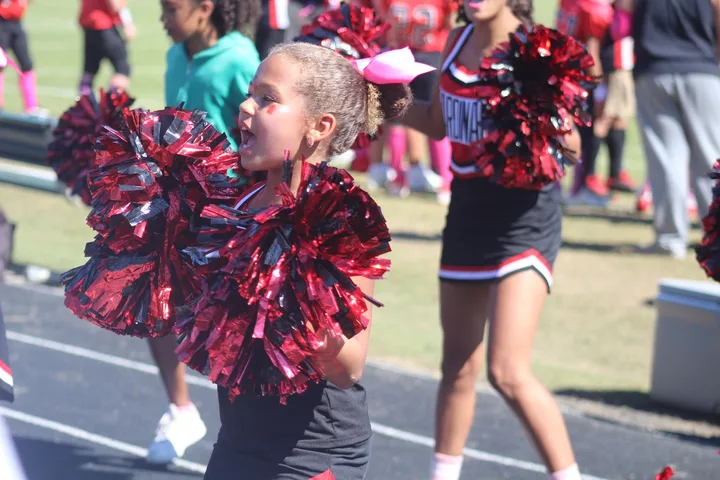 Four Oaks Cardinals cheerleaders on the sideline