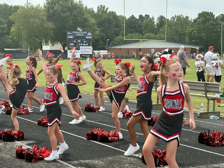 Four Oaks Cardinals cheerleaders on the sideline