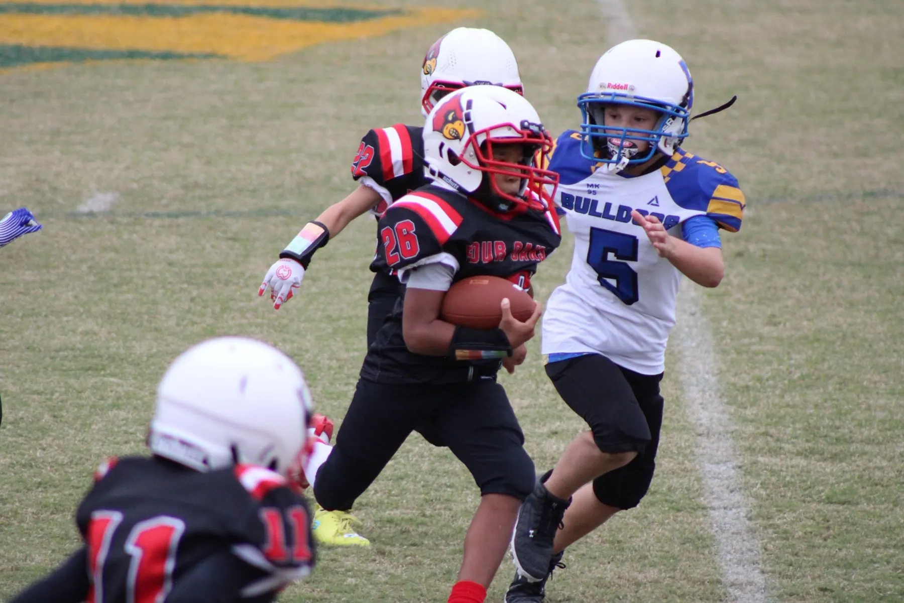 Four Oaks ball carrier running past a defender on game day