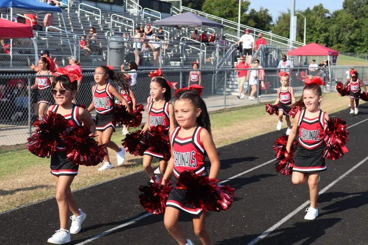 Four Oaks Cardinals cheerleaders on the sideline