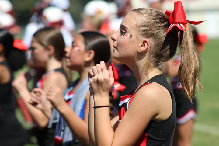 Four Oaks Cardinals cheerleaders on the sideline