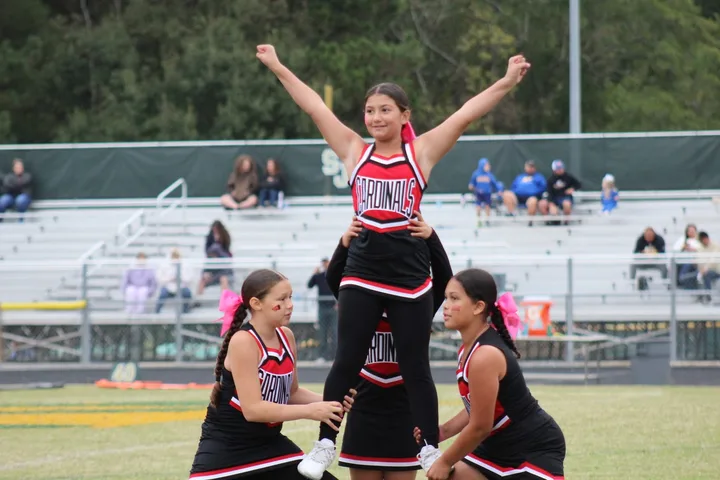 Four Oaks Cardinals cheerleaders on the sideline