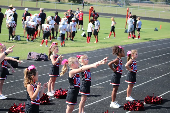 Four Oaks Cardinals cheerleaders on the sideline