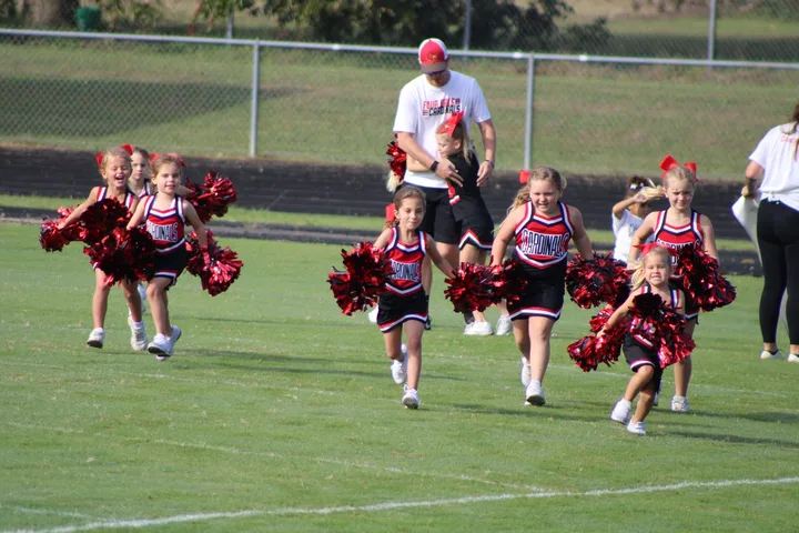 Four Oaks Cardinals cheerleaders on the sideline