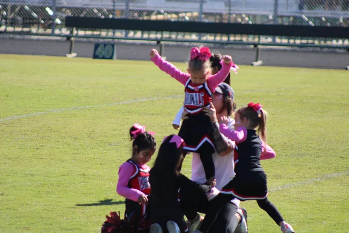 Four Oaks Cardinals cheerleaders on the sideline