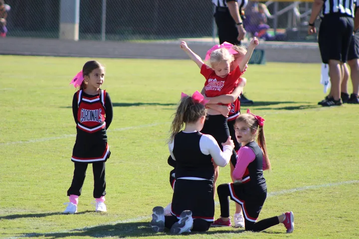 Four Oaks Cardinals cheerleaders on the sideline