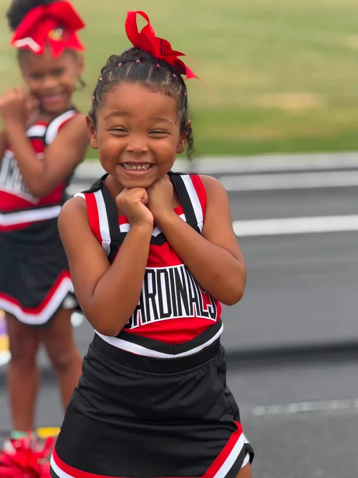 A smiling Four Oaks cheerleader on game day