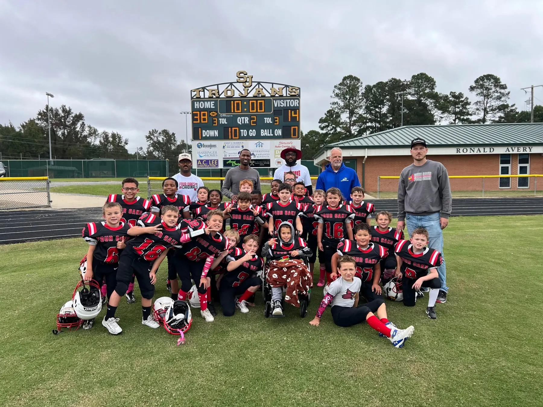 Four Oaks team photo on the field in front of the stadium scoreboard